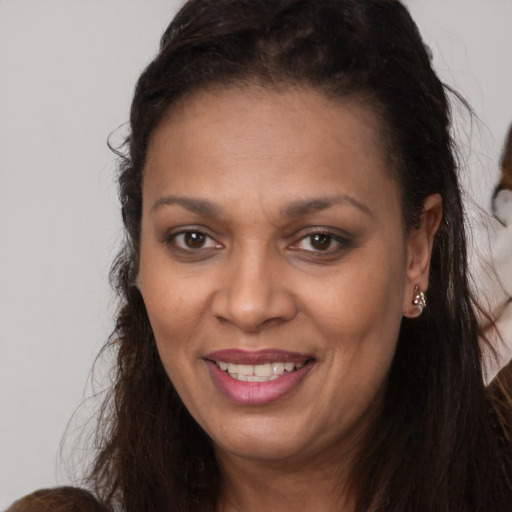 Joyful white young-adult female with long  brown hair and brown eyes