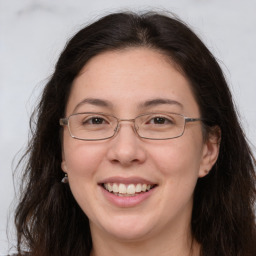 Joyful white adult female with long  brown hair and brown eyes