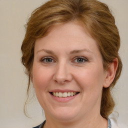 Joyful white young-adult female with medium  brown hair and blue eyes