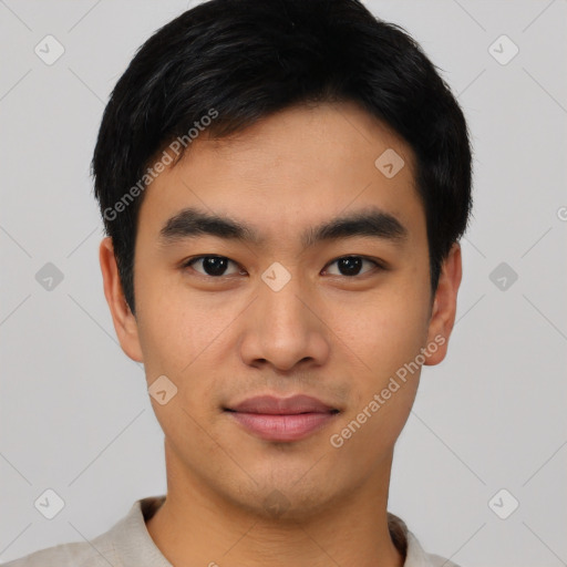 Joyful asian young-adult male with short  black hair and brown eyes