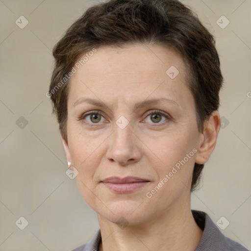 Joyful white adult female with short  brown hair and grey eyes