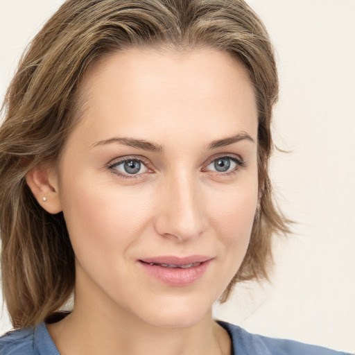 Joyful white young-adult female with medium  brown hair and blue eyes