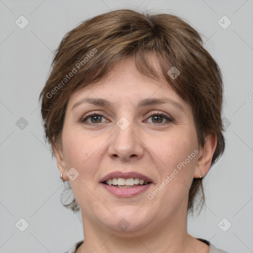 Joyful white adult female with medium  brown hair and grey eyes