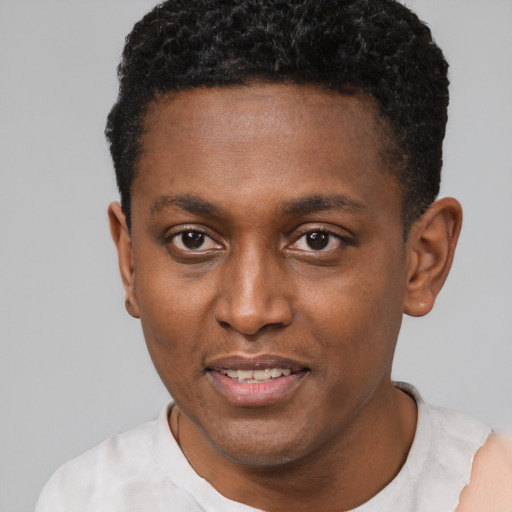 Joyful black young-adult male with short  black hair and brown eyes
