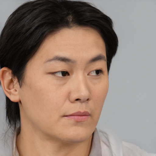 Neutral asian young-adult female with medium  brown hair and brown eyes