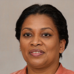 Joyful black adult female with medium  brown hair and brown eyes