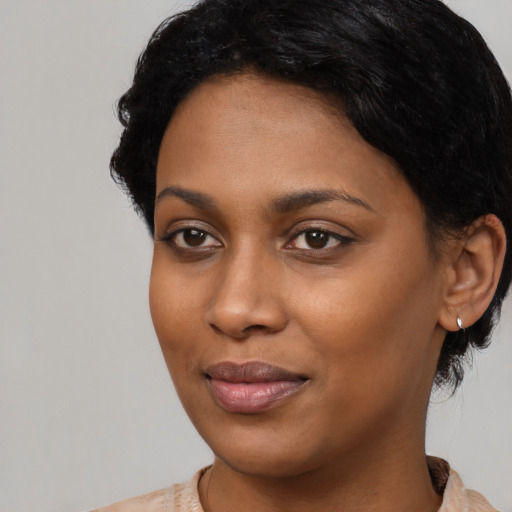 Joyful black young-adult female with medium  black hair and brown eyes