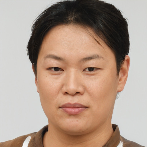 Joyful asian adult female with short  brown hair and brown eyes