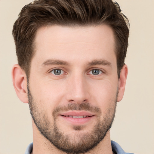 Joyful white young-adult male with short  brown hair and grey eyes