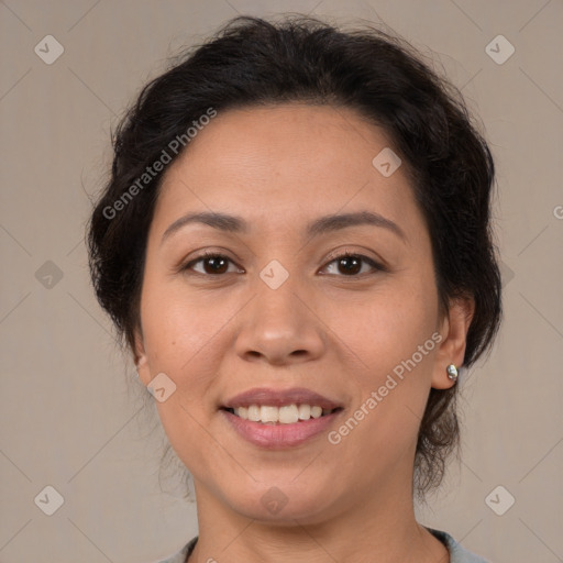 Joyful latino adult female with medium  brown hair and brown eyes