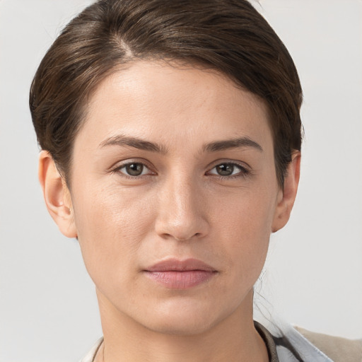 Joyful white young-adult female with short  brown hair and grey eyes