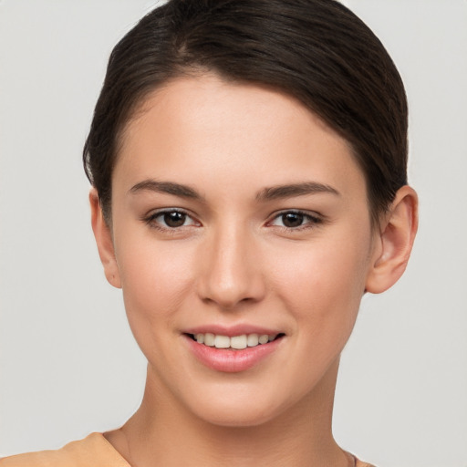 Joyful white young-adult female with short  brown hair and brown eyes