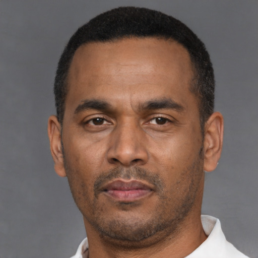 Neutral latino adult male with short  black hair and brown eyes