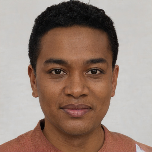 Joyful black young-adult male with short  black hair and brown eyes