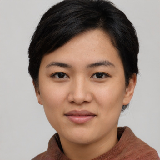 Joyful asian young-adult female with short  black hair and brown eyes