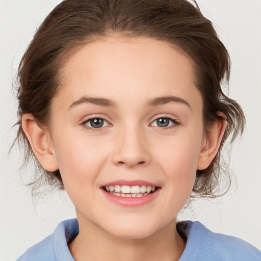 Joyful white child female with medium  brown hair and brown eyes