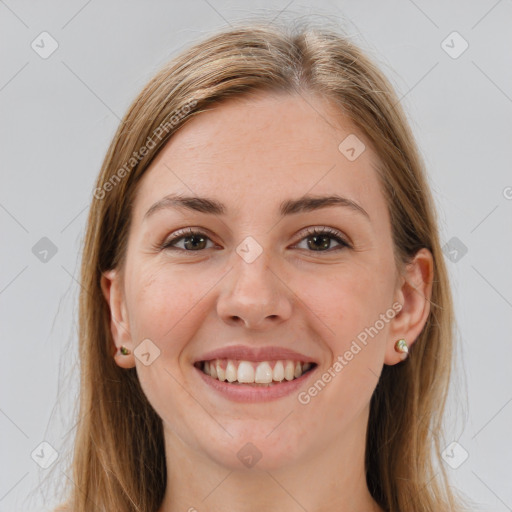 Joyful white young-adult female with long  brown hair and brown eyes