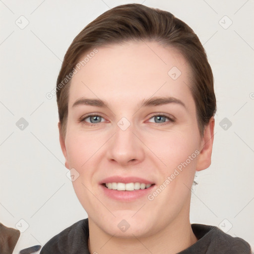 Joyful white young-adult female with short  brown hair and grey eyes