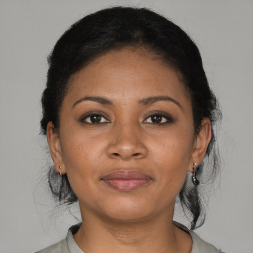 Joyful black young-adult female with medium  black hair and brown eyes