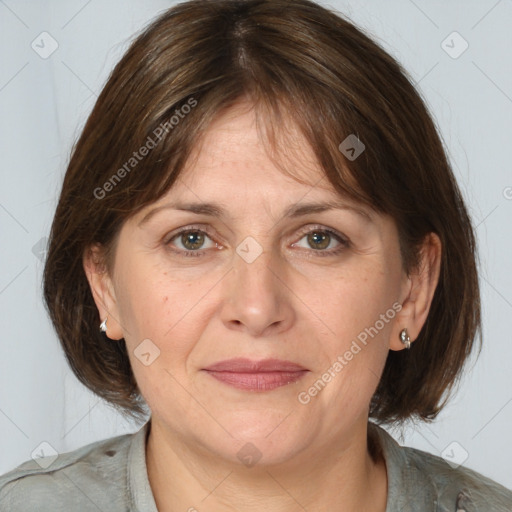 Joyful white adult female with medium  brown hair and grey eyes