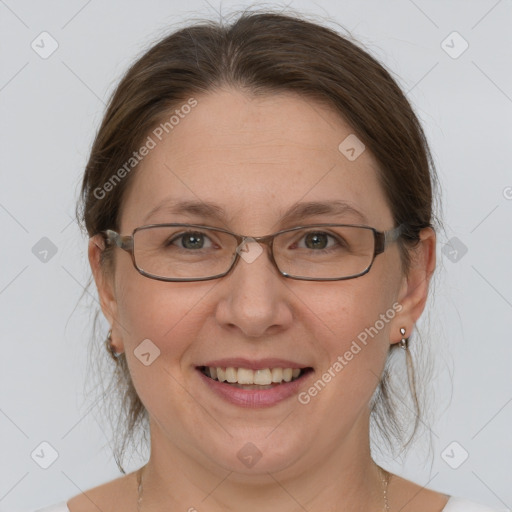 Joyful white adult female with medium  brown hair and grey eyes