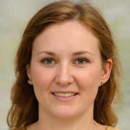 Joyful white young-adult female with long  brown hair and green eyes