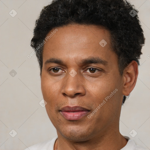 Joyful black young-adult male with short  black hair and brown eyes