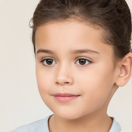 Joyful white child female with short  brown hair and brown eyes