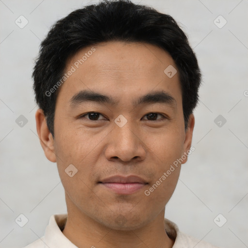 Joyful asian young-adult male with short  black hair and brown eyes