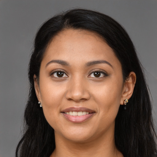Joyful latino young-adult female with long  brown hair and brown eyes
