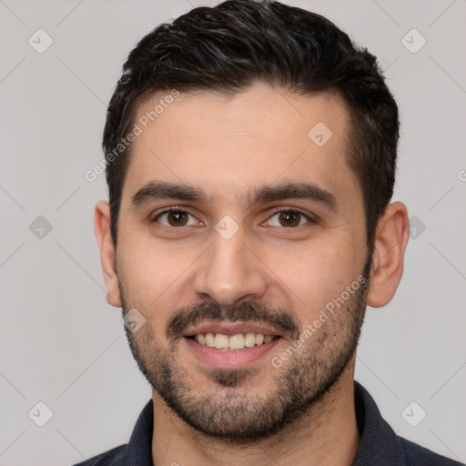 Joyful white young-adult male with short  black hair and brown eyes