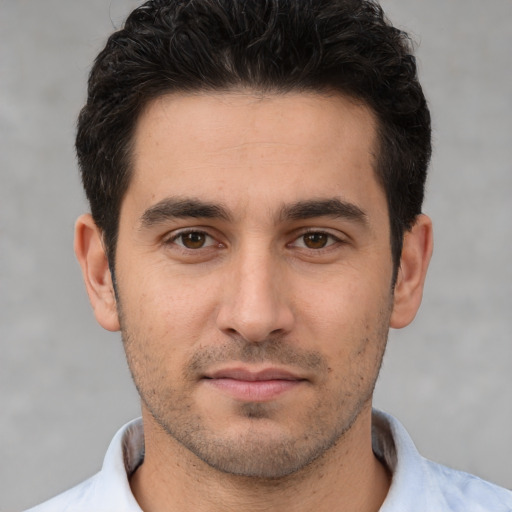 Joyful white young-adult male with short  brown hair and brown eyes