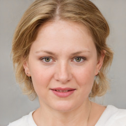 Joyful white young-adult female with medium  brown hair and blue eyes