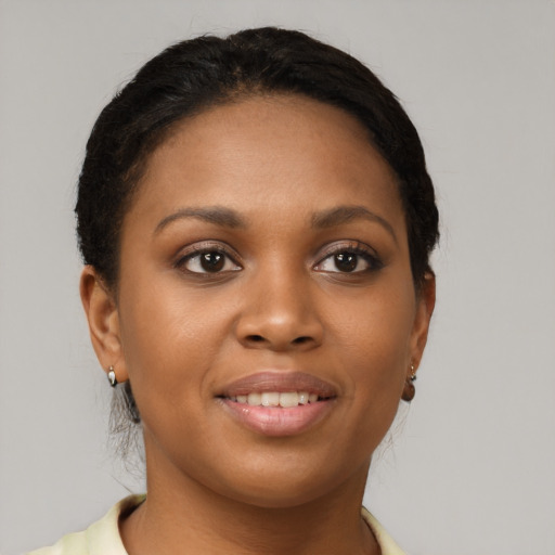 Joyful black young-adult female with short  brown hair and brown eyes