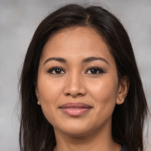 Joyful asian young-adult female with long  brown hair and brown eyes
