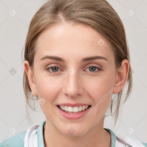 Joyful white young-adult female with medium  brown hair and blue eyes