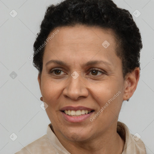 Joyful latino adult female with short  brown hair and brown eyes