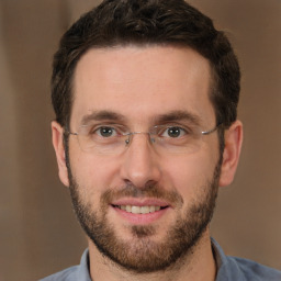 Joyful white adult male with short  brown hair and brown eyes
