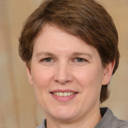 Joyful white adult female with medium  brown hair and grey eyes