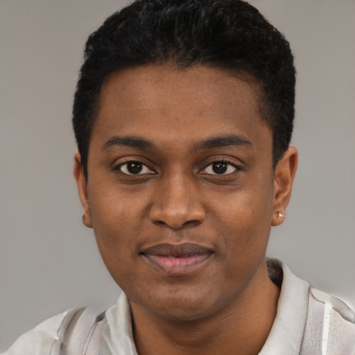 Joyful black young-adult male with short  black hair and brown eyes