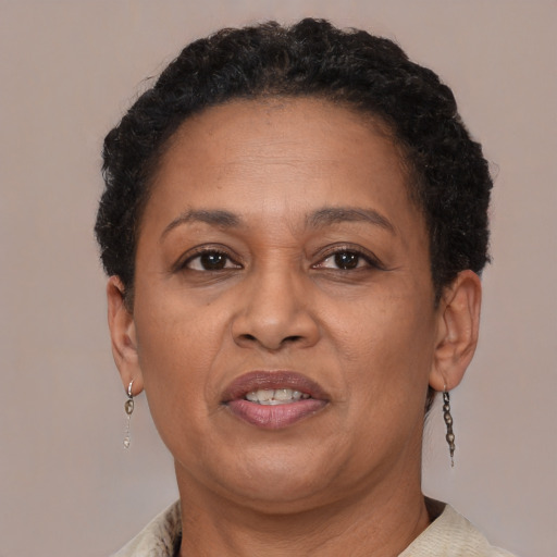 Joyful black adult female with short  brown hair and brown eyes