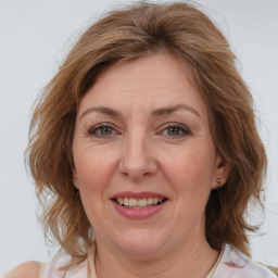 Joyful white adult female with medium  brown hair and brown eyes