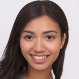 Joyful latino young-adult female with long  brown hair and brown eyes