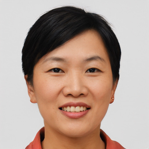 Joyful asian young-adult female with short  black hair and brown eyes