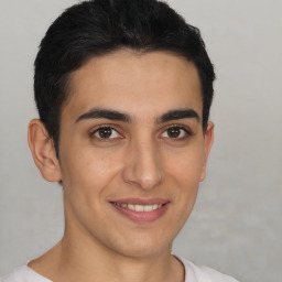 Joyful latino young-adult male with short  brown hair and brown eyes