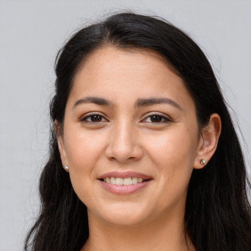 Joyful latino young-adult female with long  brown hair and brown eyes