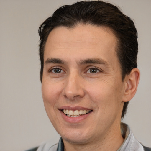 Joyful white adult male with medium  brown hair and brown eyes