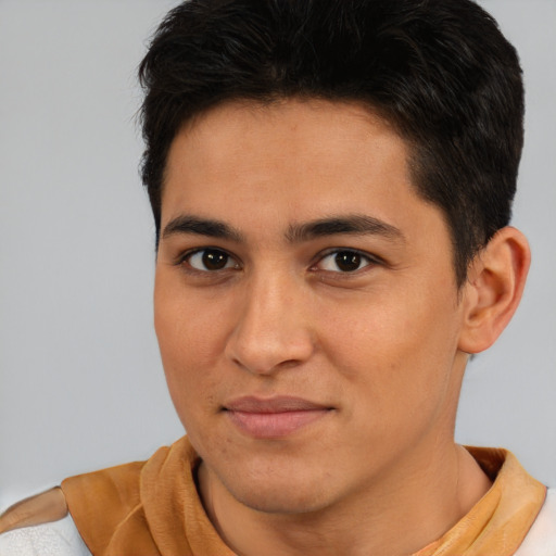 Joyful latino young-adult male with short  brown hair and brown eyes