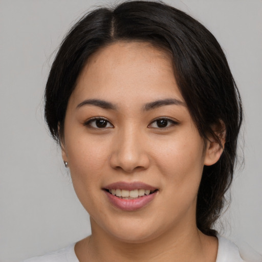 Joyful asian young-adult female with medium  brown hair and brown eyes