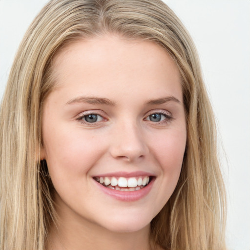 Joyful white young-adult female with long  brown hair and green eyes